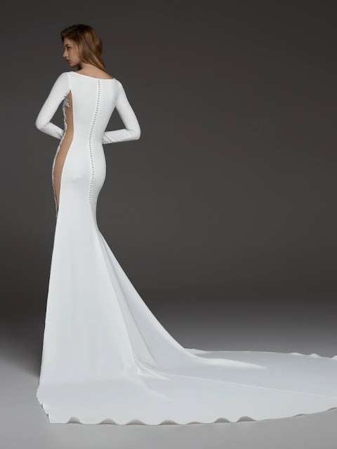Camilla - elegance of crepe, a flattering bateau neckline, sophisticated long sleeves with a breath-taking side slit K'Mich Weddings - wedding planning - wedding dresses - camilla - pronovias collection