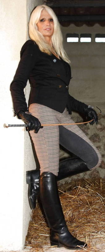 Sexy dominatrix in riding boots