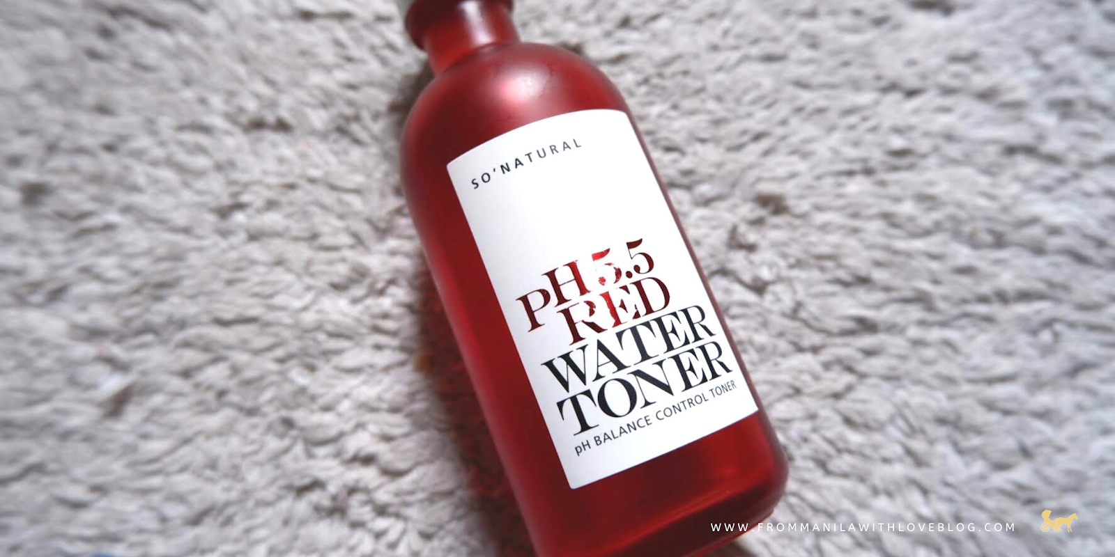 an image of a matte glass red bottle on a rug