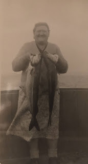 Mary Urban Endrich holding two large fish