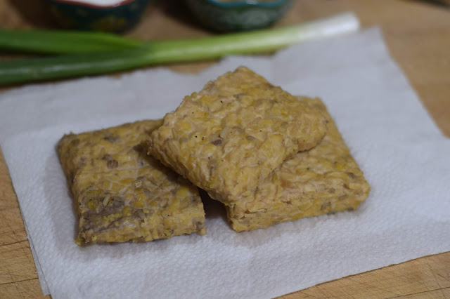 The boiled tempeh, on paper towel, on the counter. 