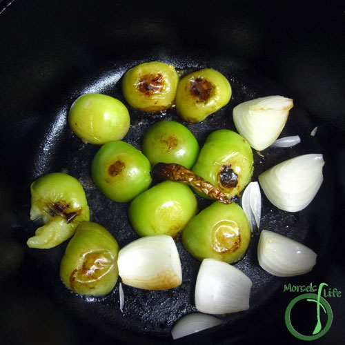 Morsels of Life - Tomatillo Salsa Verde Step 2 - Pan roast tomatillos and onion by coating bottom of a skillet with a bit of oil. Sear one side of tomatillos, and then flip to brown other side.