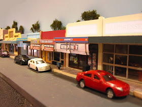Quarter inch scale modern Australian town street scene with newsagents and cars parked outside.