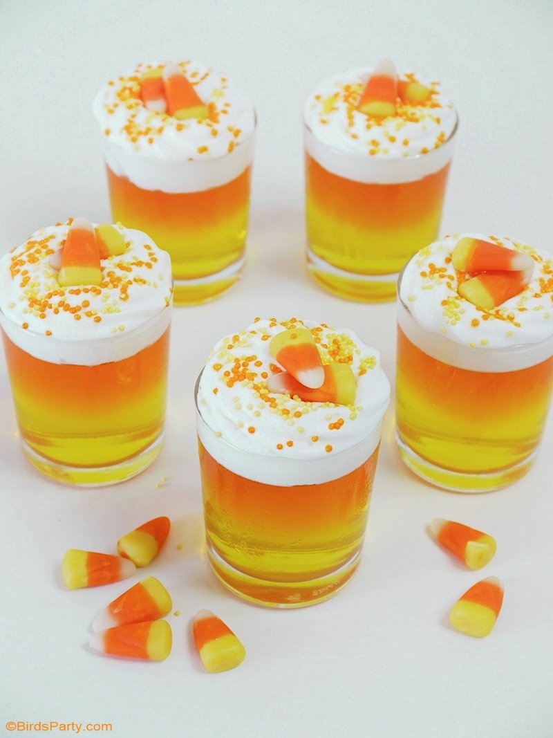 Halloween Candy Corn Jello Cups - a pretty, quick and easy to make and inexpensive dessert recipe to serve at your Halloween party! by BirdsParty.com @birdsparty #halloween #candycorn #jello #jelloshots #jellocups #halloweenrecipes #halloweendessert #halloweenjello