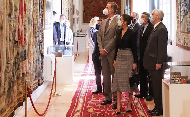 Queen Letizia wore a black v-neck silk shirt from Sandro, and pointed-check wool skirt from Massimo Dutti