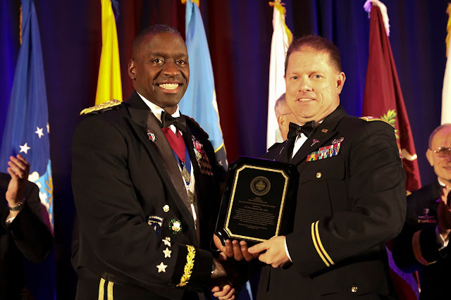Two men accepting an award