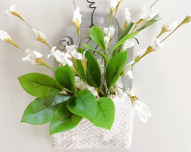 wall pocket with white flowers and greens