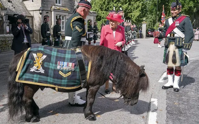 The Queen wore a raspberry pink coat and a matching hat, with a floral dress