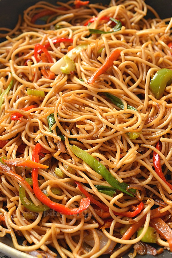A pan with easy veggie lo mein with lots of vegetables and sauce mix