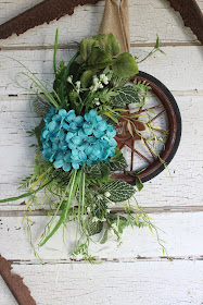 upcycled wheel wreath or door hanging.