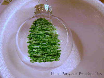 Painting the branches of the painted Christmas tree ornament