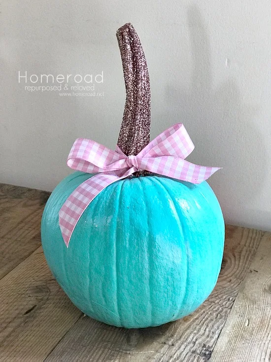 Painted pumpkin with ribbon and glittered stem