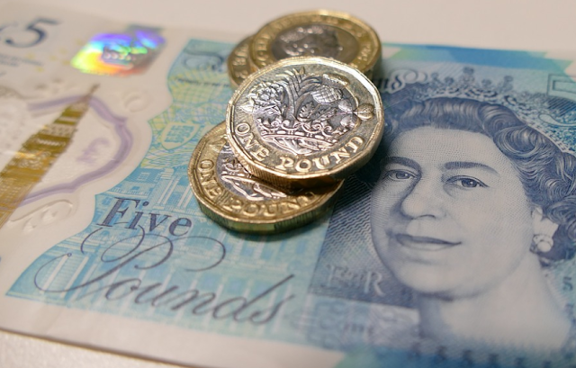 A five pound note and some coins.