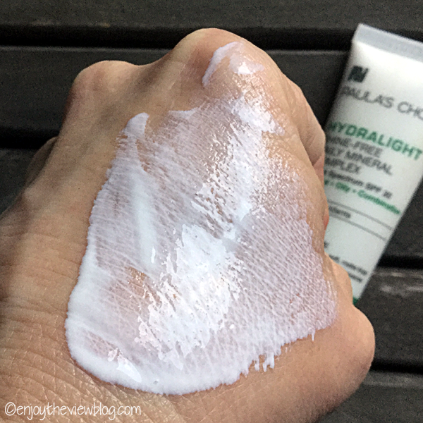 Paula's Choice Hydralight Shine-Free Daily Mineral Complex spread out on the back of a hand