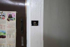 Polaroid photo taped to wall