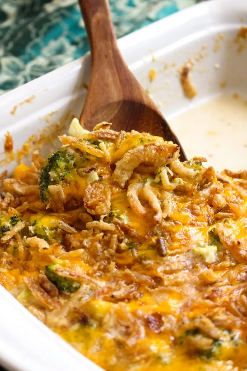 This Broccoli Cheddar Casserole is made with tender broccoli, a creamy cheddar cheese sauce, and french fried onions. It will be the hit of your next holiday dinner! #sidedishrecipes #broccoli #broccolicasserole