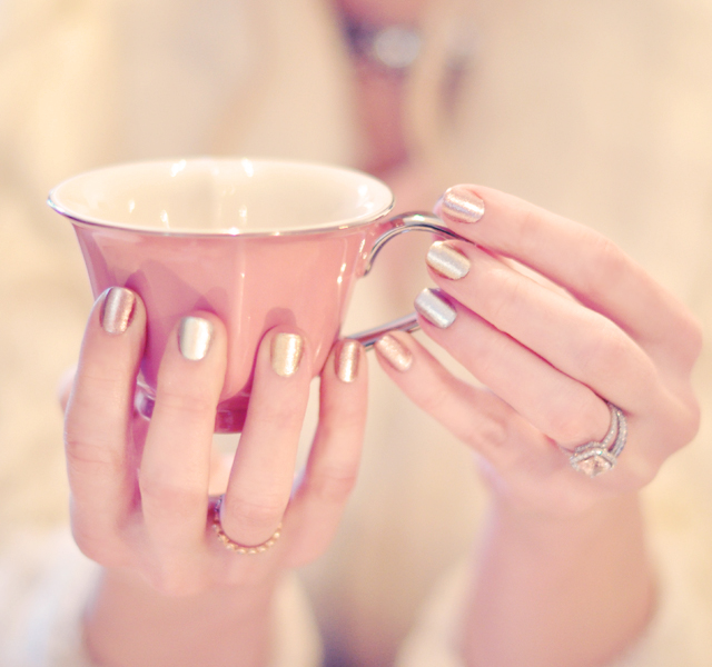 metallic nails, holding a pink heart teacup