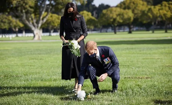 Meghan Markle wore a new black wool and silk jacket from Brandon Maxwell, and a silk belt from same brand. Jennifer Chamandi Lorenzo suede pumps