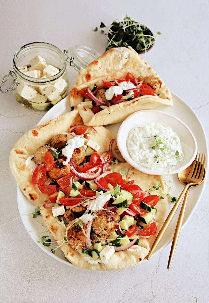 Crispy-Greek-Meatballs-with-Tzatziki-and-Feta-1 Recipe for crispy baked chicken meatballs with oregano, tzatziki sauce and marinated feta cheese.