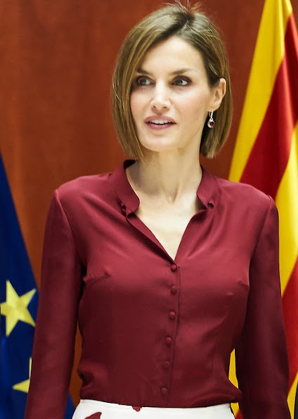 Queen Letizia attended an official lunch for Constitutional Tribunal. Felipe Varela satin blouse and floral skirt