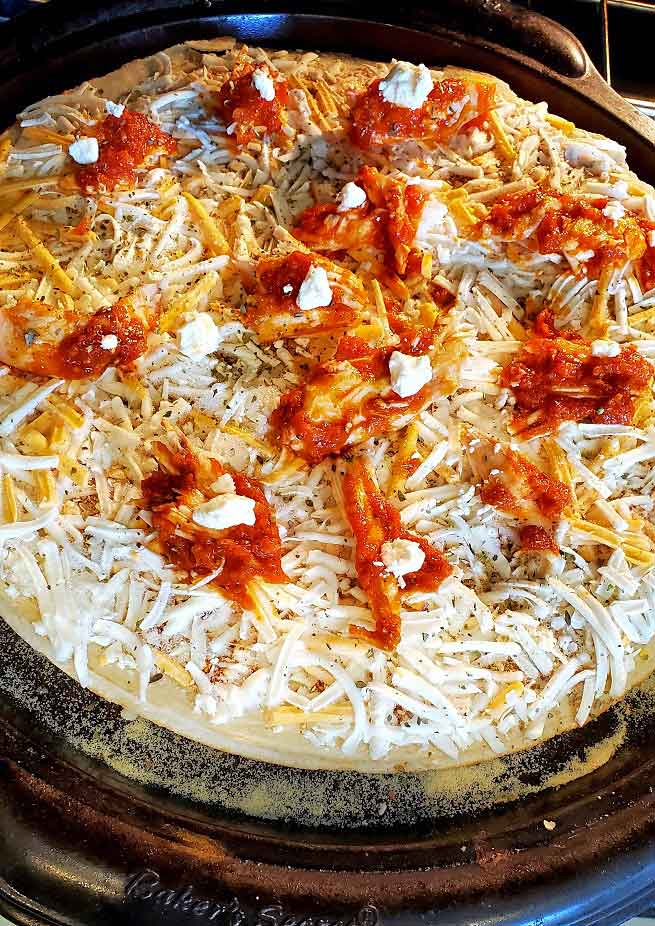 this is a pizza topped with cheddar and buffalo chicken sauce with chicken