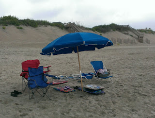 chairs and an umbrella at the beach