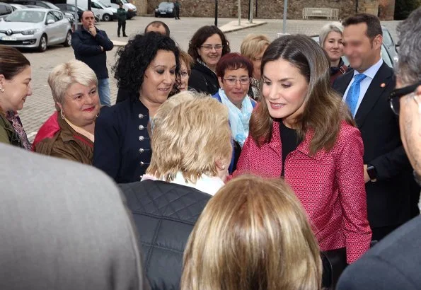 Queen Letizia wore Uterque Black leather pants and Uterque red coat. Queen Letizia wore Carolina Herrera black patent and suede pumps