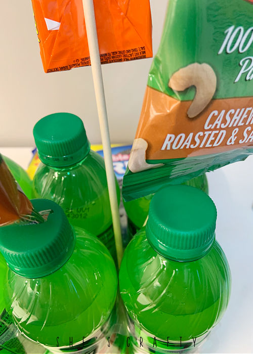 How to make a birthday bouquet - stick dowels in between soda bottles.