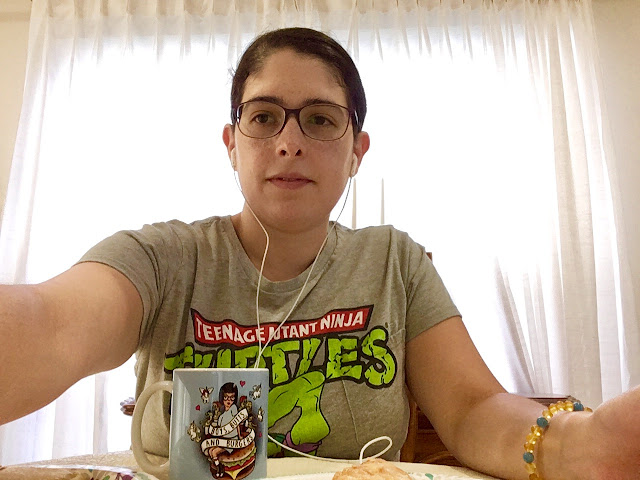 headphones in, glasses on, mug, amber bracelet, ready to vlog