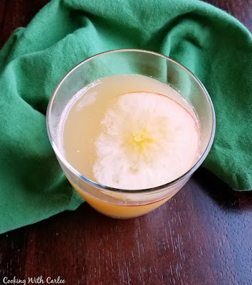This caramel apple punch couldn't be simpler to make. With just 3 ingredients, it takes almost no time to make. It is perfect for fall parties! looking down at a glass of caramel apple punch
