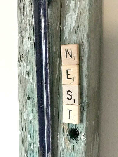 Chippy board with a nest and Scrabble letters