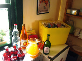 Selection of miniature dolls' house non-alcoholic drinks arranged in a kitchen, ready for a party.
