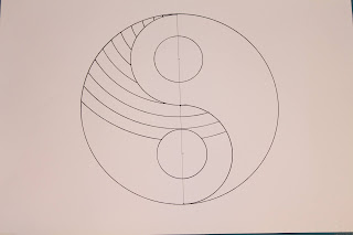 This is the image of a yin yang symbol with circle lines on one side