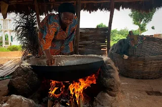 Mynebre in Tanzania cooking over an open fire with her favorite cooking pot