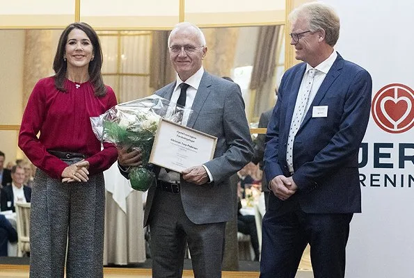 Danish Crown Princess Mary wore Hugo Boss Banora8 blouse and wool trousers at Hotel d'Angleterre in Copenhagen. Danish Heart Association