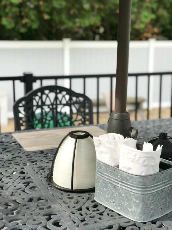 candle lantern with silverware organizer on table