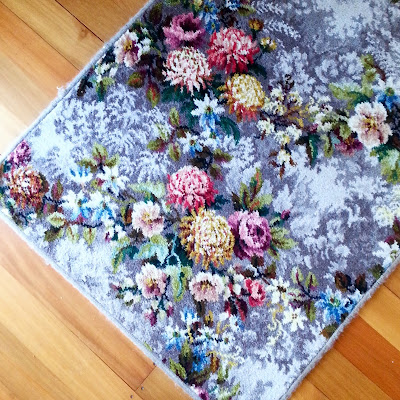 Floor rug made of a piece of vintage Axminster floral carpet.