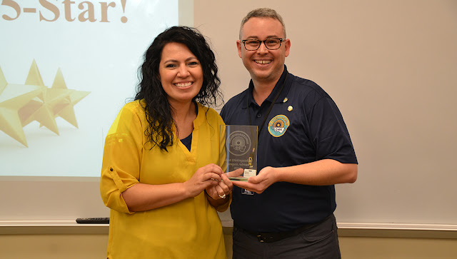 a man and a woman holding a glass award