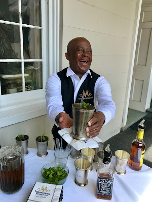 Bartender Roosevelt Owens serves one of his famous mint juleps. 
