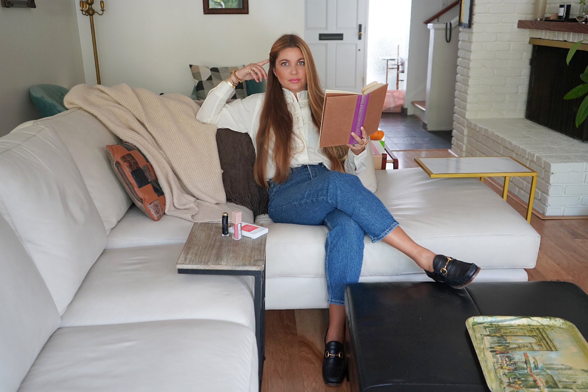 woman in her Preppy Beauty Look and sitting in her living room