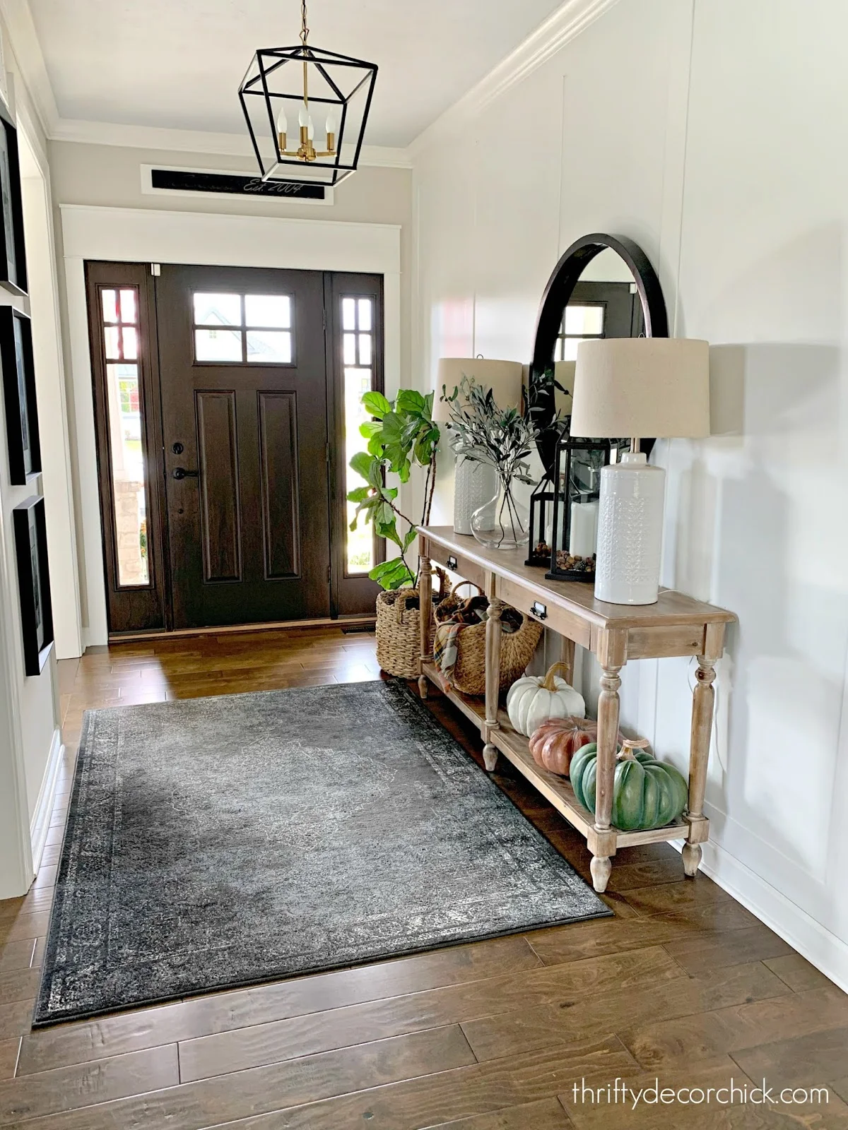 foyer with Everett table and white walls with molding