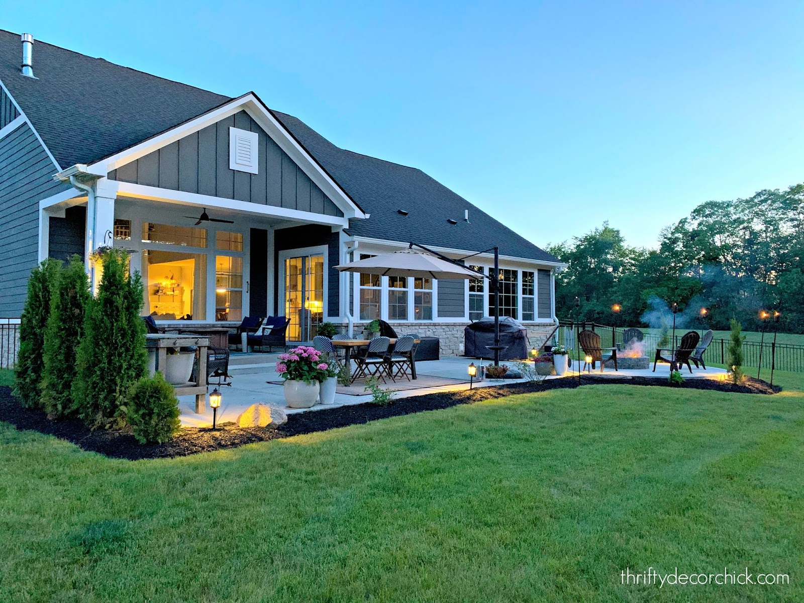 Backyard patio with fire pit modern Craftsman home 