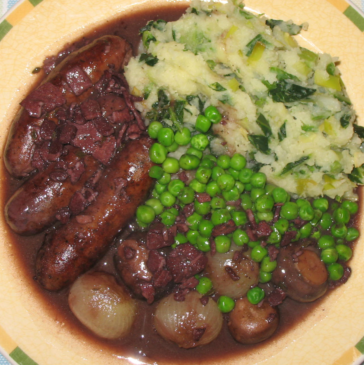 The Happy Housewife Sausages braised in red wine with Colcannon mash