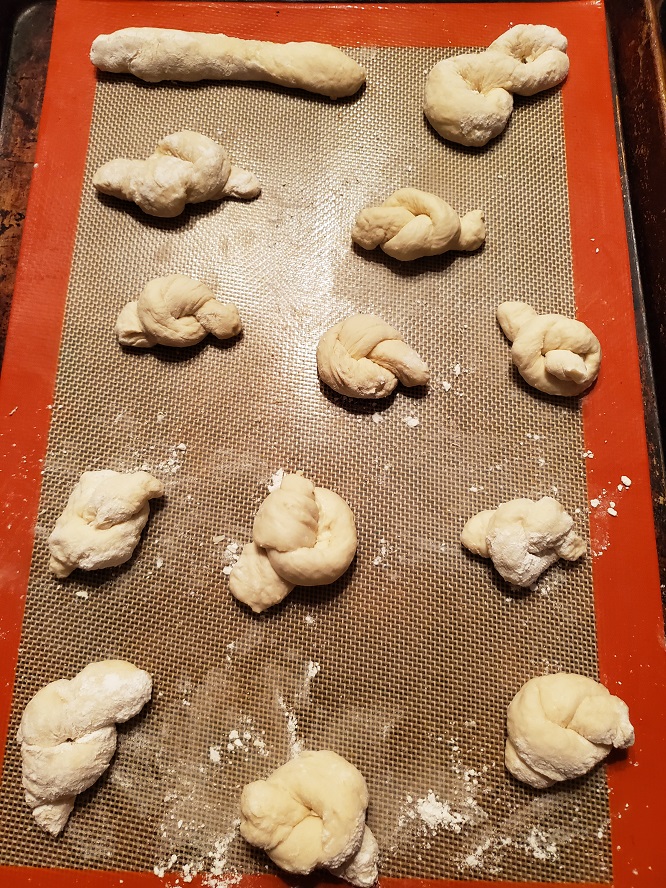 These are raw garlic knots on a cookie sheet rising
