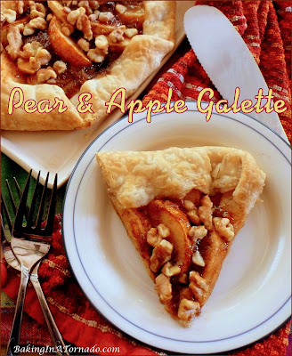 Pear and Apple Galette, a rustic version of a pie featuring fresh pear and apple slices, baked in a pie crust with a hint of apricot and the crunch of walnuts. | Recipe developed by www.BakingInATornado.com | #recipe #dessert