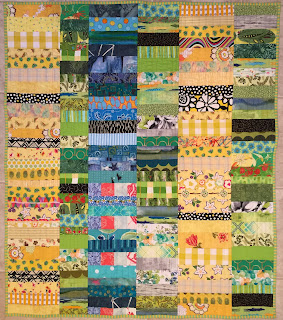 Chinese Coins VII quilt has columns of yellow, green, and blue scraps