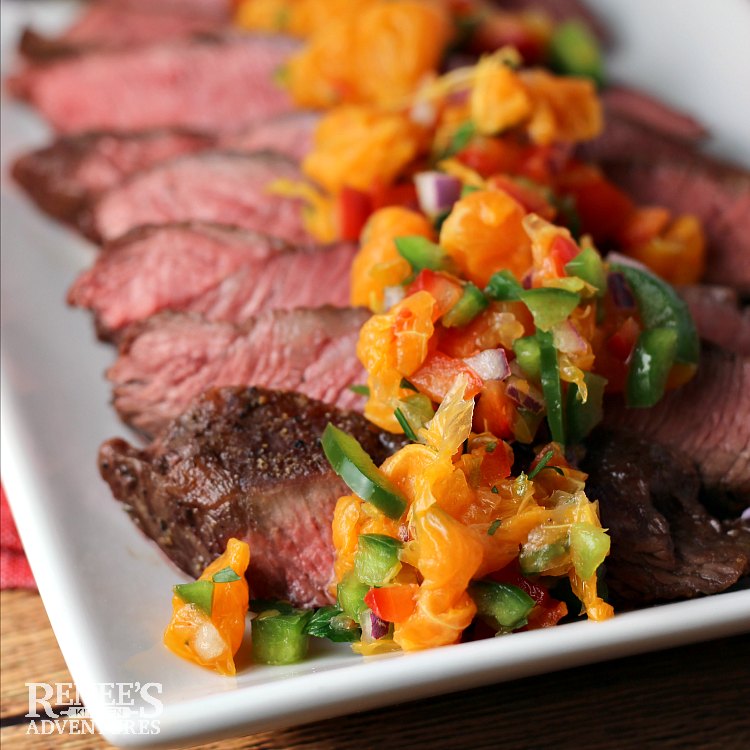 Sliced Flat Iron Steak with Citrus Salsa by Renee's Kitchen Adventures on a white plate, close up