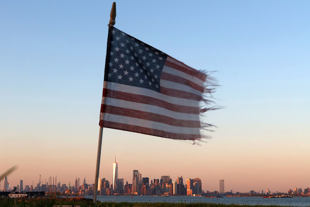 Tattered flag New York City skyline