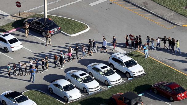 PHOTO: People are brought out of the Marjory Stoneman Douglas High School after a shooting, Feb. 14, 2018, in Parkland, Florida. (Joe Raedle/Getty Images)