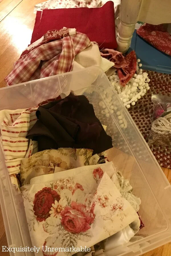 Messy pile of fabric scraps in a plastic bin